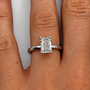 2.02 carat emerald-cut solitaire diamond ring in white gold worn on hand