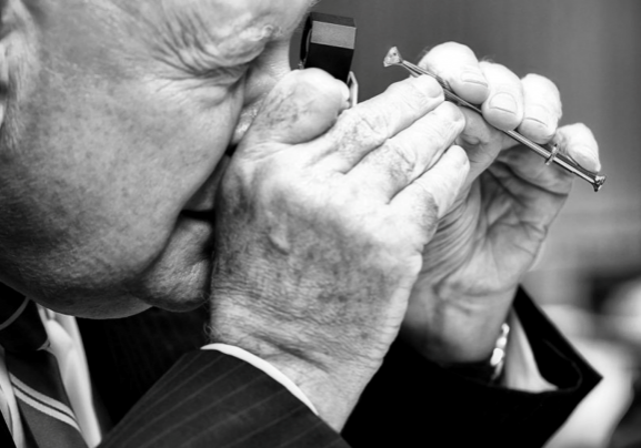 Craig Rosendorff inspecting diamonds with a jeweler's loupe