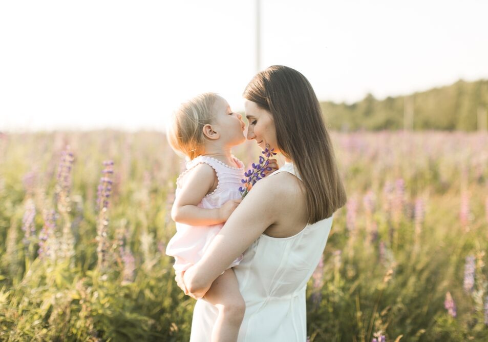 Mother,Holds,Her,Child,In,Her,Arms,,Nature,,Tranquility